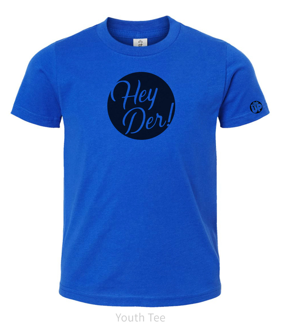 black circle with "Hey Der!" in modern script on blue youth t-shirt, "Little UP" in circle small on sleeve