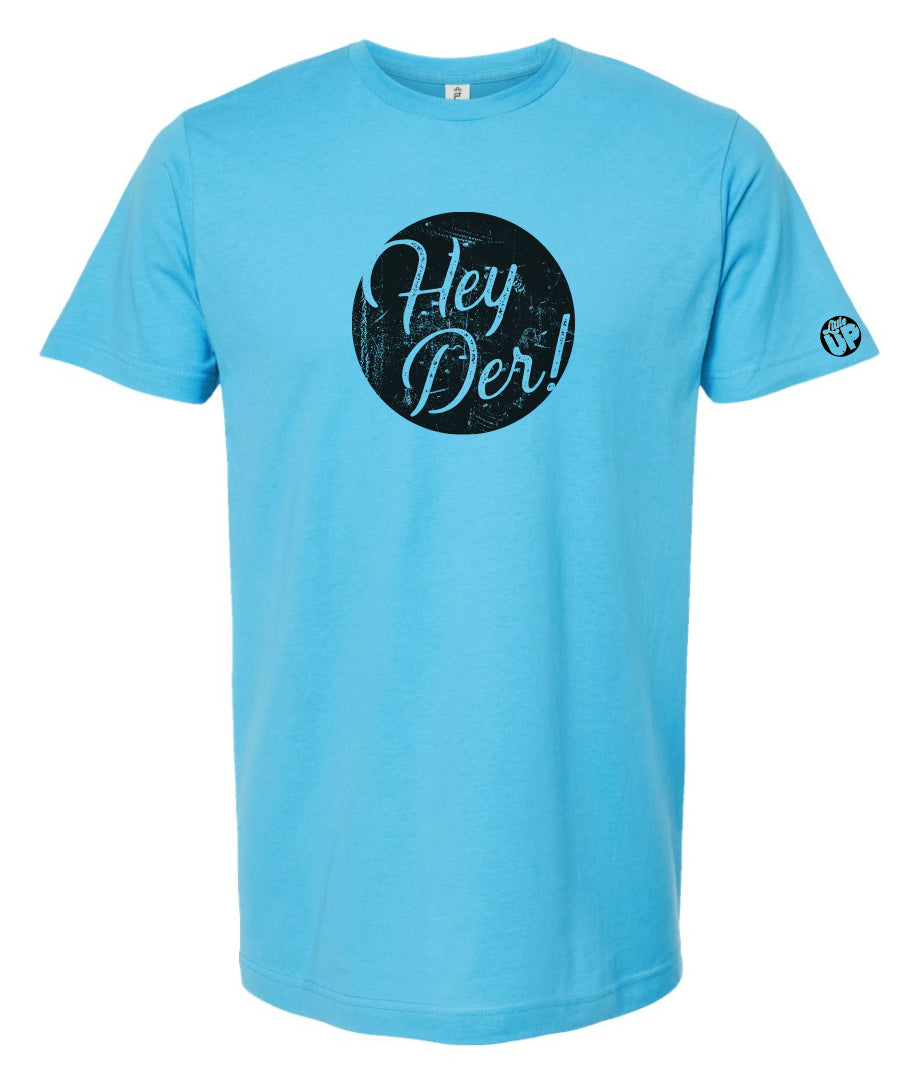 "Hey Der!" in modern textured script in black circle on light blue t-shirt