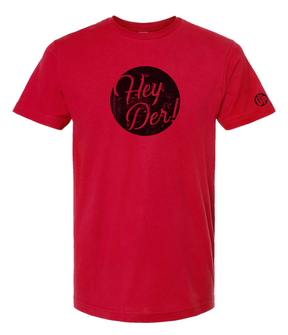 "Hey Der!" in modern textured script in black circle on red t-shirt
