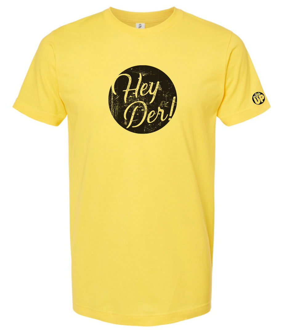 "Hey Der!" in modern textured script in black circle on yellow t-shirt