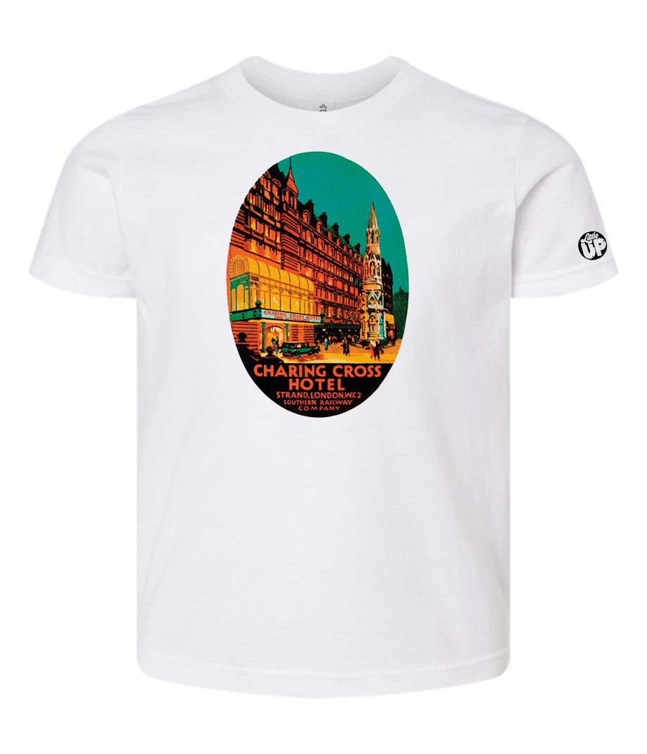oval illustration of old hotel in London, colors include orange, teal green, yellow and black, printed on white t-shirt on white background