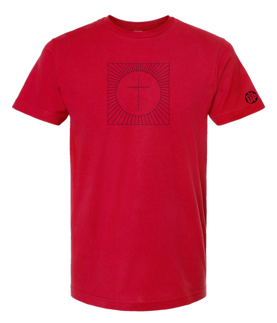 simple cross in a circle which is in a square with lines radiating from the circle to the square, printed in black on a red t-shirt