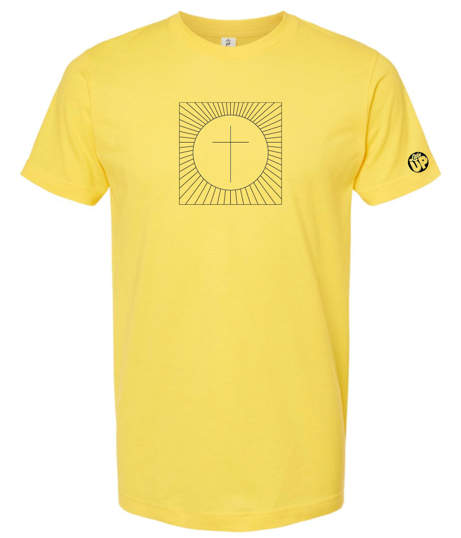 simple cross in a circle which is in a square with lines radiating from the circle to the square, printed in black on a yellow t-shirt