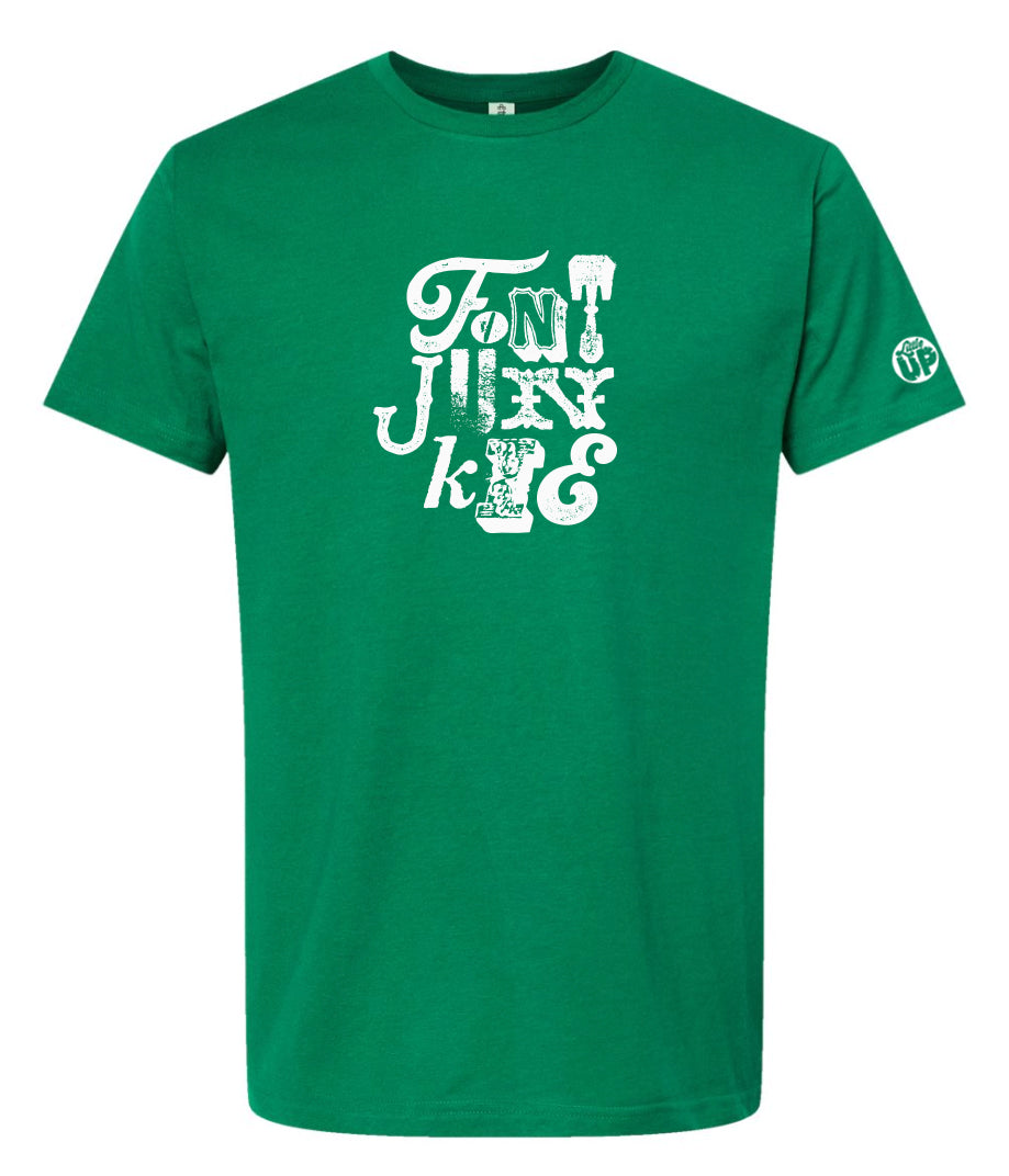 "FONT JUNKIE" in white with each letter a different font on Kelly green t-shirt