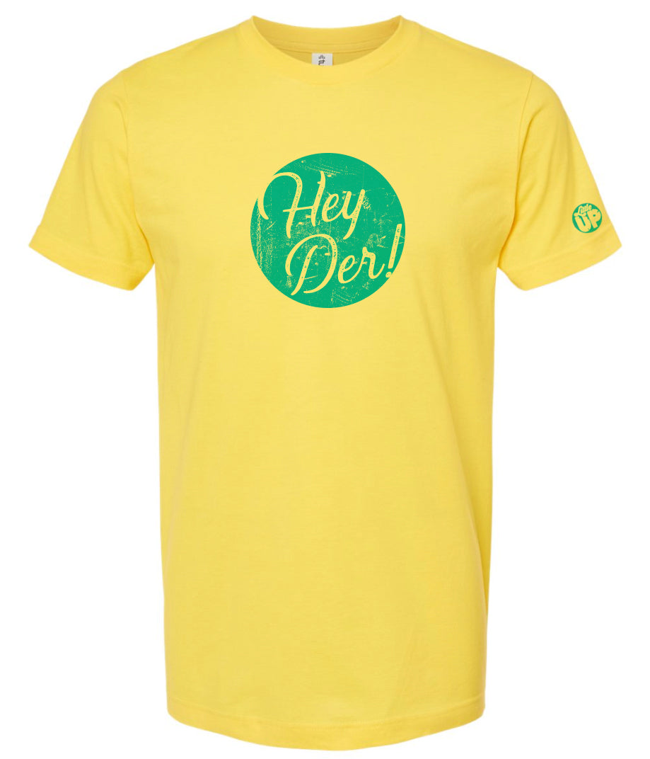 "Hey Der!" in script font, white on textured light blue circle, on yellow t-shirt on white background