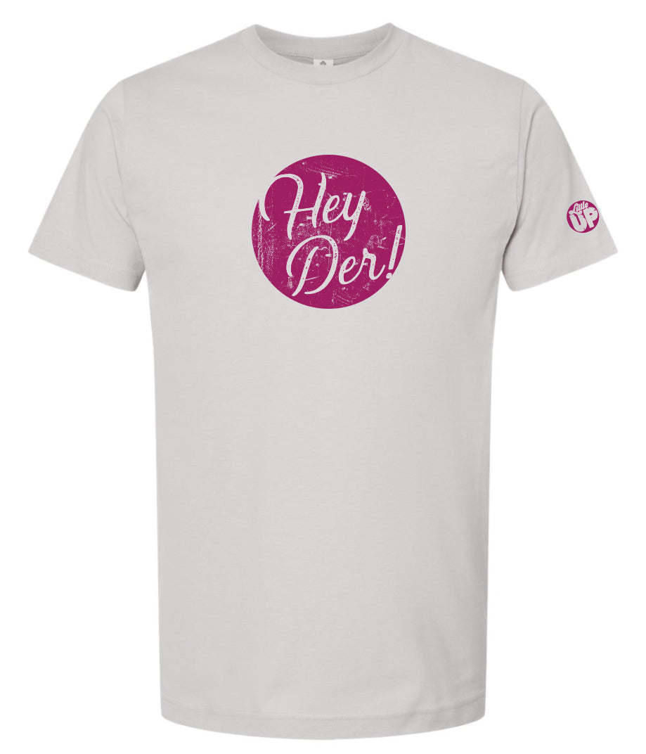 "Hey Der!" in script font, white on textured purple circle, on silver t-shirt on white background