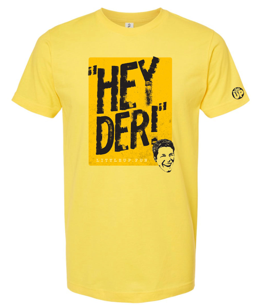 "HEY DER!" large in black on yellow box with young man with big smile in the lower right corner on yellow t-shirt