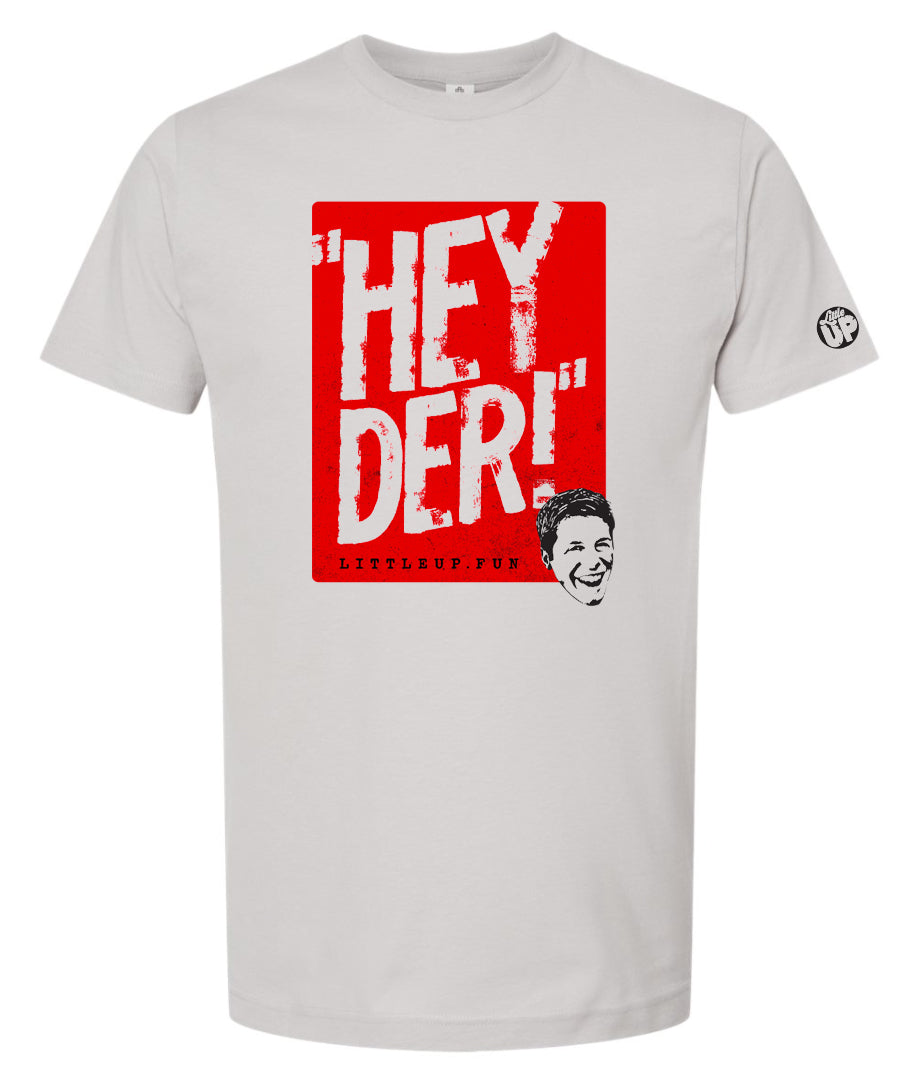 "HEY DER!" large in red box with young man with big smile in the lower right corner on silver t-shirt