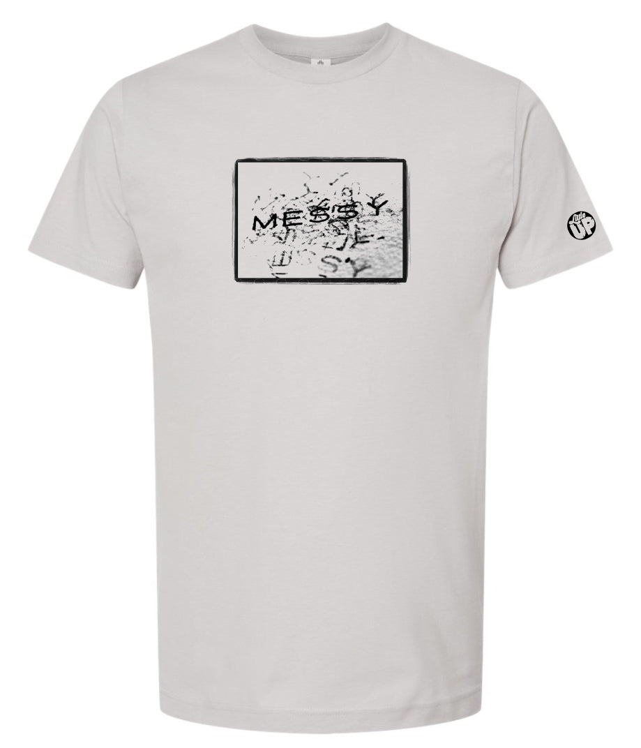 photo of "MESSY" stamped repeatedly with rough border on light gray t-shirt on white background