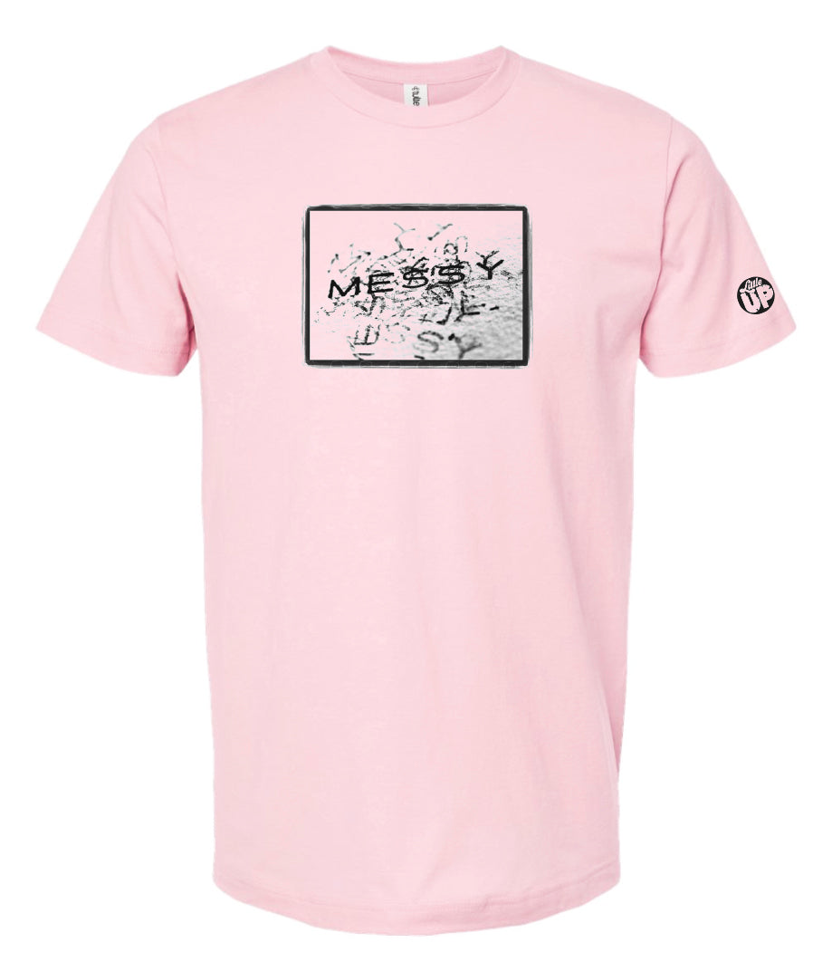 photo of "MESSY" stamped repeatedly with rough border on pink t-shirt on white background