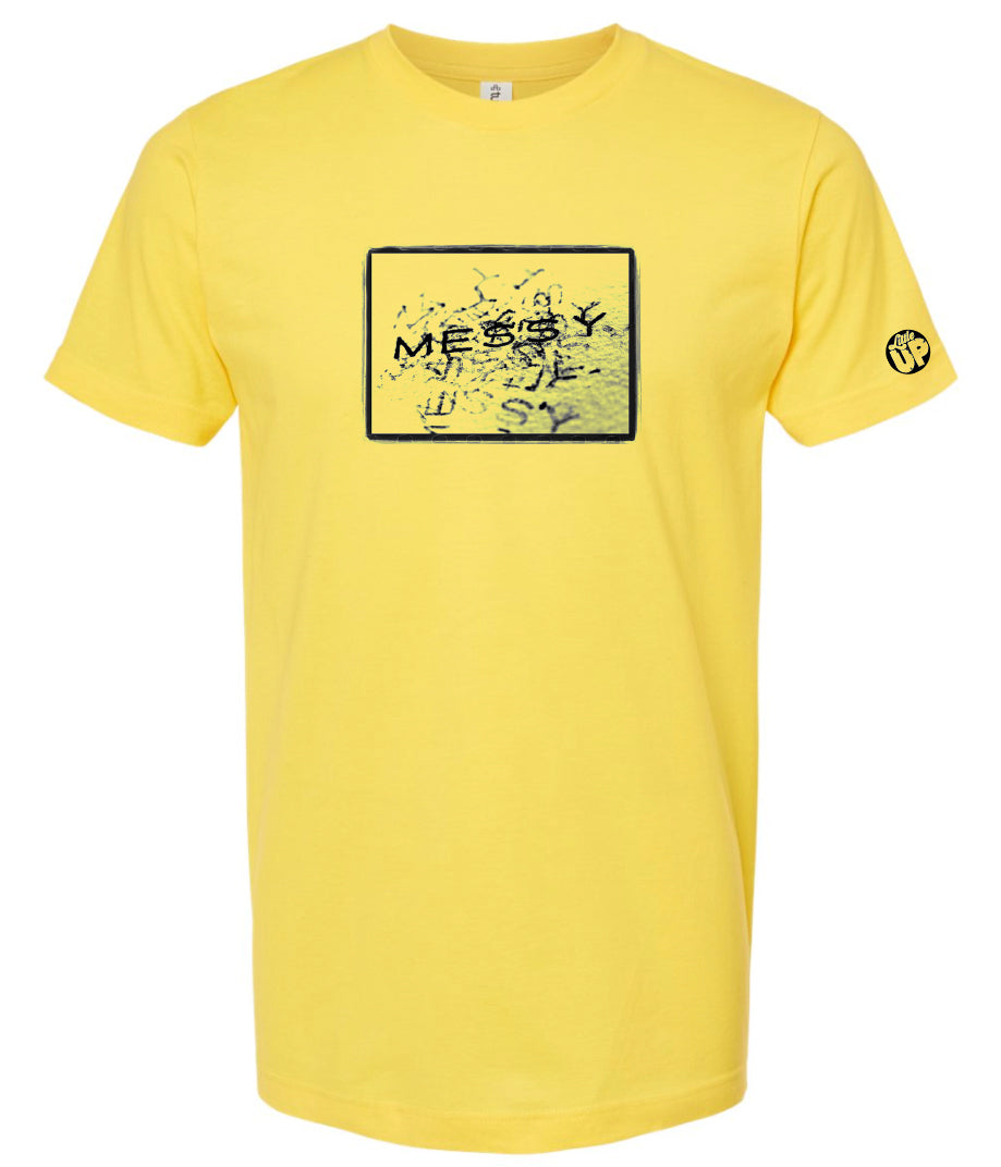 photo of "MESSY" stamped repeatedly with rough border on light gray t-shirt on yellow background