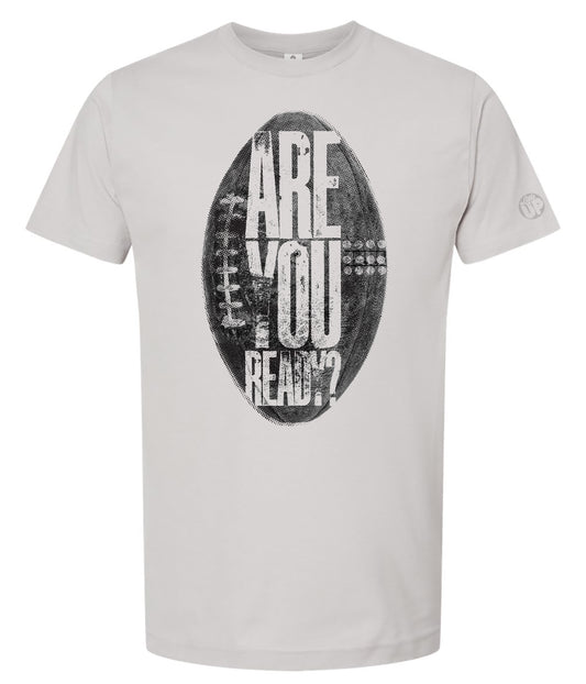 White t-shirt featuring a large, distressed graphic of a football with the words "Are You Ready?" in bold white letters, creating an energetic tone.