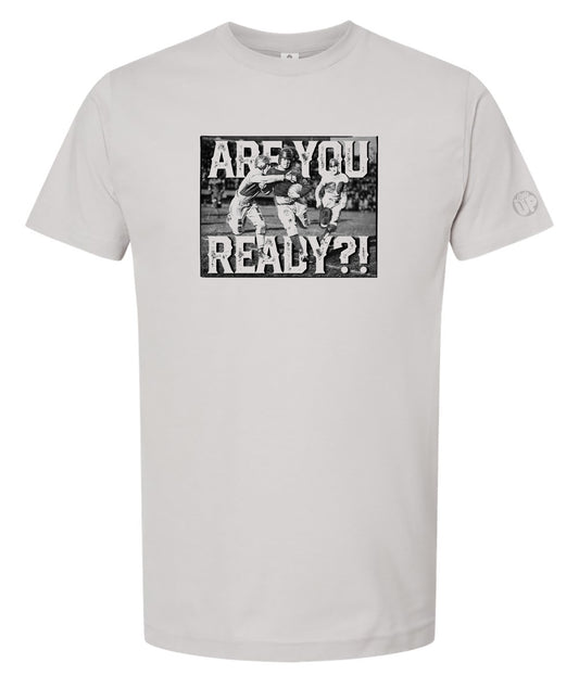 Light gray t-shirt featuring a vintage-style image of three football players in action with bold text "ARE YOU READY?!" conveying excitement and anticipation.