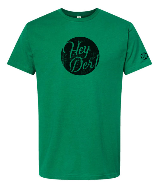 "Hey Der!" in modern textured script in black circle on green t-shirt