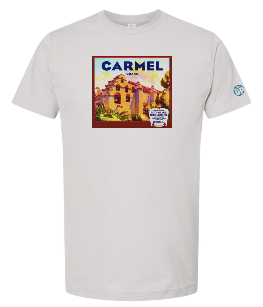 vintage "Carmel Brand" packaging graphic with old mission looking structure with terra cotta roof and stucco sides on silver tee on white background