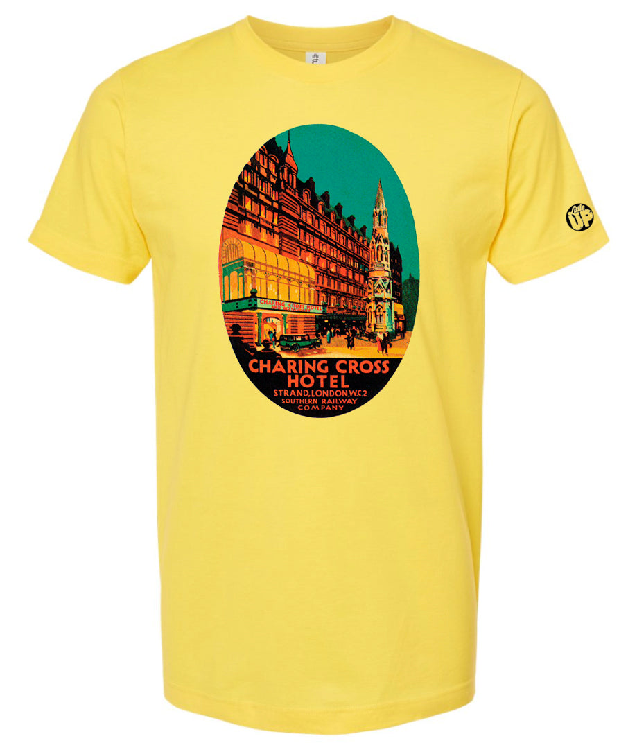 oval illustration of old hotel in London, colors include orange, teal green, yellow and black, printed on pink t-shirt on white background