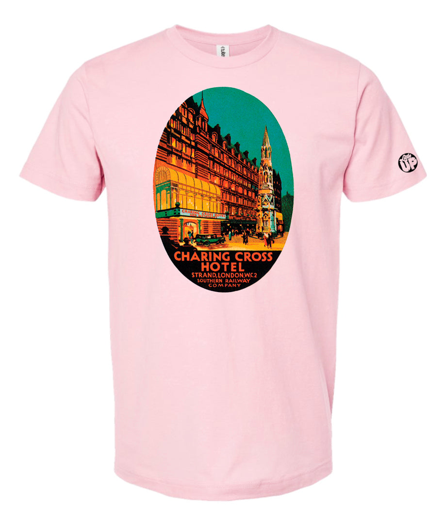 oval illustration of old hotel in London, colors include orange, teal green, yellow and black, printed on pink t-shirt on white background