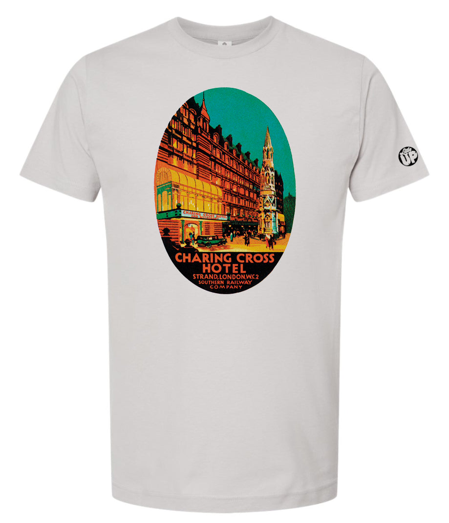 oval illustration of old hotel in London, colors include orange, teal green, yellow and black, printed on light gray t-shirt on white background