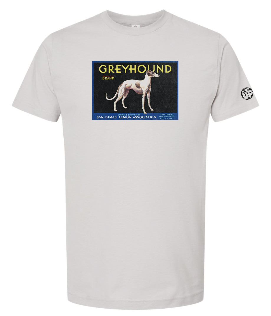 vintage packaging with illustration of white greyhound with a few large brown spots, "GREYHOUND" is the headline, printed on light gray t-shirt