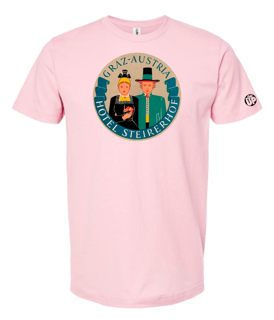 vintage round illustration of old hotel in Austria, colors include blue, orange, teal, yellow and black, printed on pink t-shirt on white background