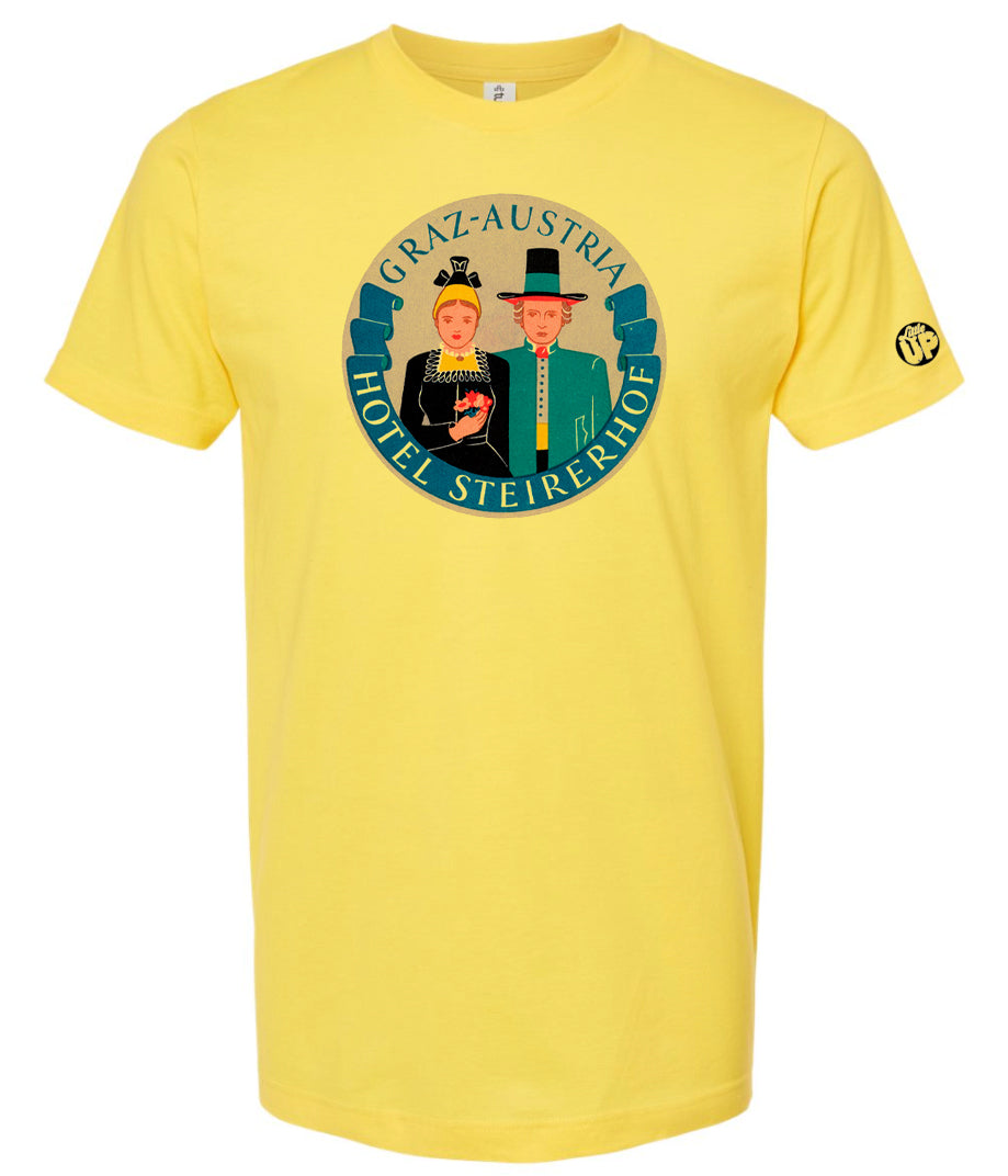 vintage round illustration of old hotel in Austria, colors include blue, orange, teal, yellow and black, printed on yellow t-shirt on white background