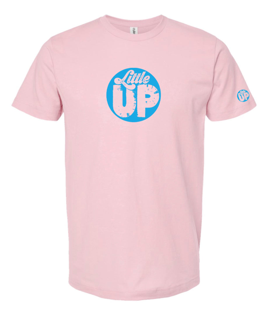 light blue circle logo with "Little" in the top third in textured seventies script and "UP" on the bottom ⅔ in modern sans serif textured font on pink t-shirt on white studio background