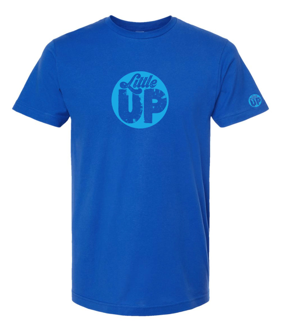 light blue circle logo with "Little" in the top third in textured seventies script and "UP" on the bottom ⅔ in modern sans serif textured font on royal blue t-shirt on white studio background