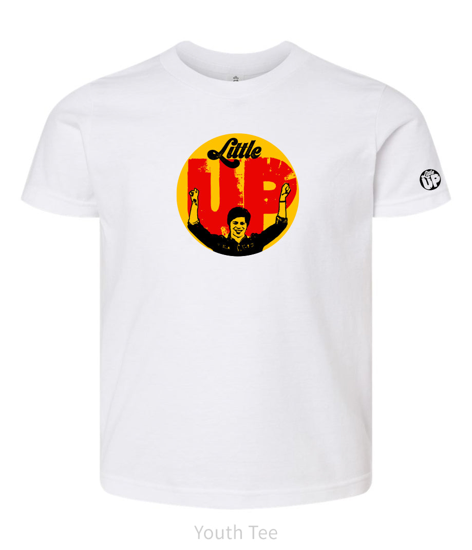 large circle with "Little" at the top in 70s script, "UP" large in red textured sans serif, illustration of young man smiling with arms raised illustration in black at the bottom, on white youth t-shirt