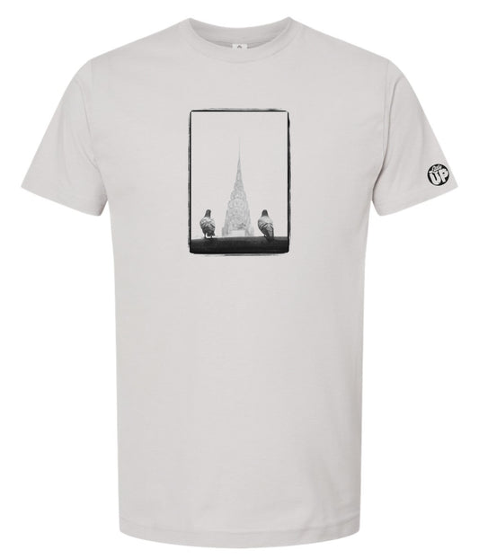 black and white photo of two pigeons in the foreground and the Chrysler Building in the background between the pigeons, on gray t-shirt
