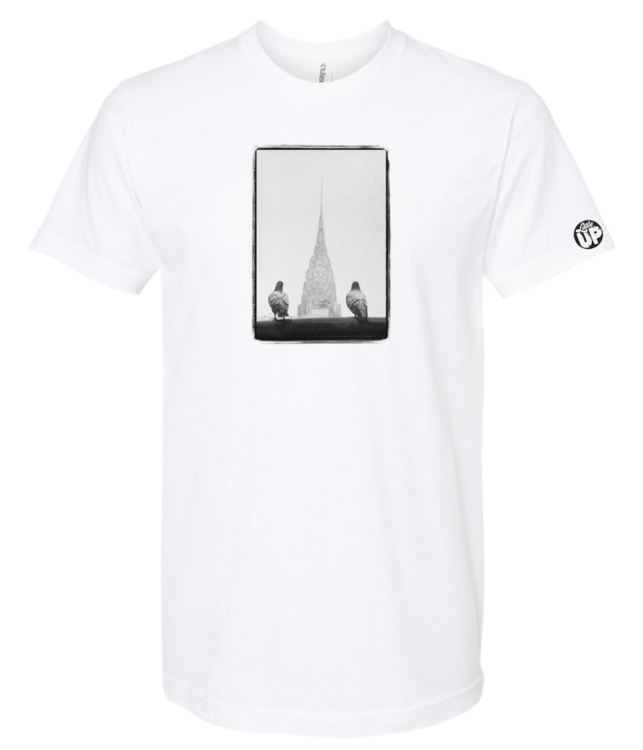 black and white photo of two pigeons in the foreground and the Chrysler Building in the background between the pigeons, on white t-shirt
