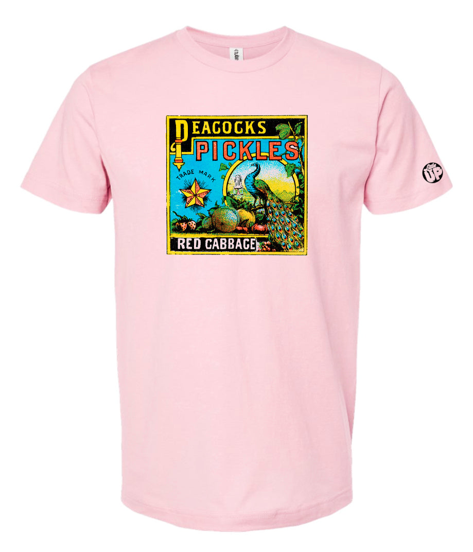 vintage graphic for "Peacocks Pickles" includes an illustration of a peacock, colors are yellow, red, light blue and black on pink t-shirt